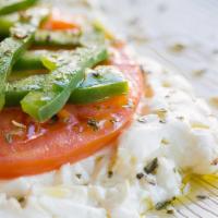 Feta Fournou (Baked Feta Cheese) · Feta cheese baked with a slice of tomato and a slice of green pepper, topped with extra virg...