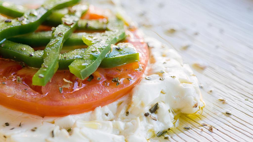 Feta Fournou (Baked Feta Cheese) · Feta cheese baked with a slice of tomato and a slice of green pepper, topped with extra virgin olive oil and oregano.