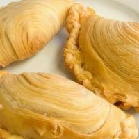 Curry Puff (Chicken Curry) · Handmade Thai pastry is flavorful, filled with chicken and curry.