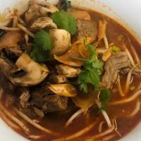 Beef Tom Yum Noodle Soup · Thai style rice noodle soup with beef, bean sprouts, fried garlic, cilantro and scallions.