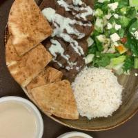 Lamb Gyro · Lamb gyro, rice, Greek salad, pita bread, tahini, baba ghanouj, and soup.