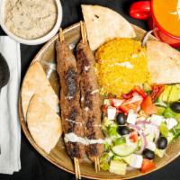 Kuftah · Kuftah, rice, Greek salad, pita bread, tahini, Baba ghanouj, and soup.