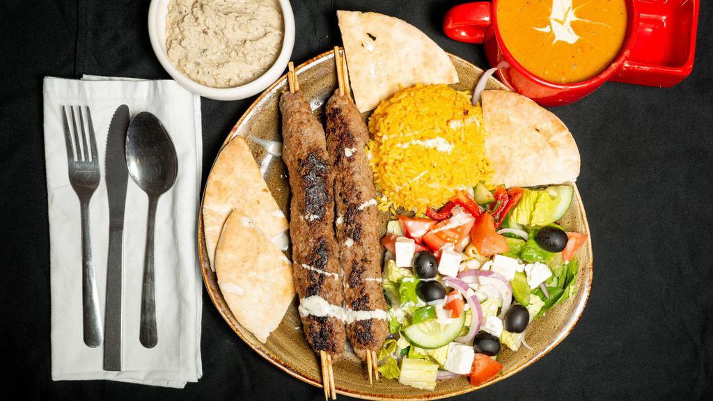 Kuftah · Kuftah, rice, Greek salad, pita bread, tahini, Baba ghanouj, and soup.