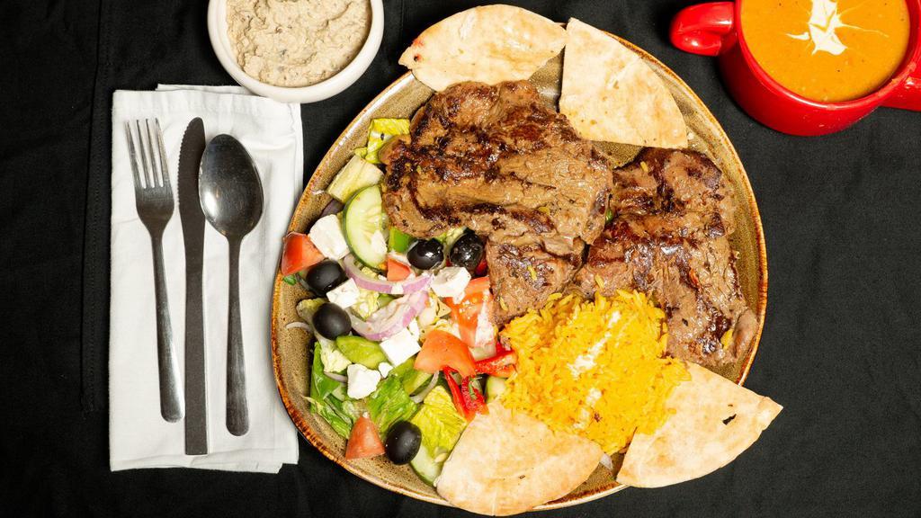 Grilled Beef · Grilled beef, rice, Greek salad, pita bread, tahini, Baba ghanouj, and soup.