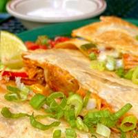 Quesadilla De Pollo · Served on a 12” flour tortilla. Stuffed with achiote chicken, poblanos, roasted peppers and ...