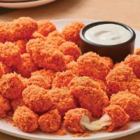 Cheetos® Cheese Bites · Crispy Cheese Bites tossed in sauce and coated in crunchy original Cheetos® crumbles. Served...