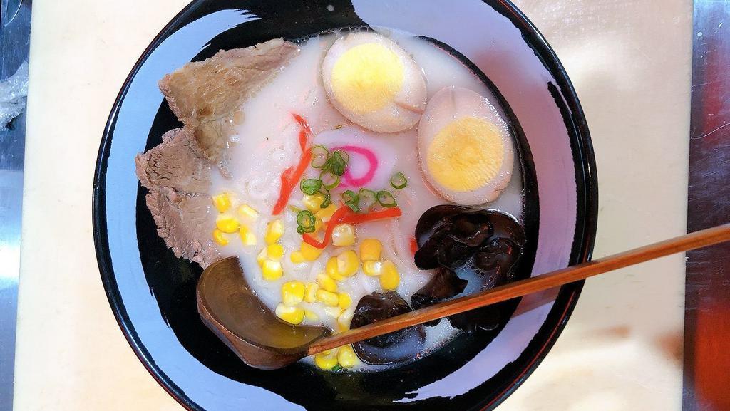 Tonkotsu Ramen · Tonkotsu base in pork broth, corn, wood ear, fish cake, red ginger, egg, sliced pork, scallions.