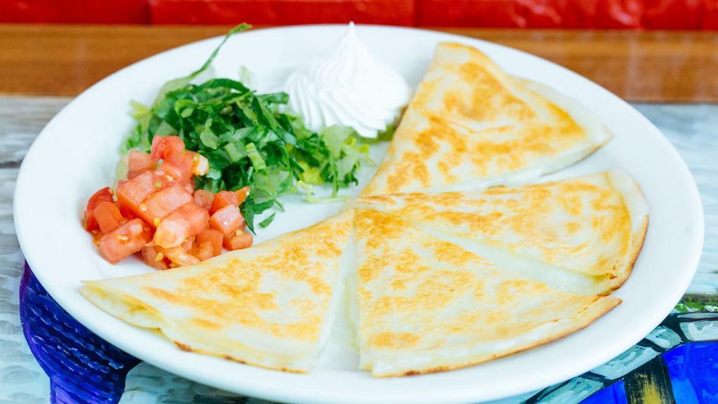Grilled Quesadilla · Try our delicious quesadilla stuffed with cheese and your choice of filling. Served with side of lettuce, tomato, and sour cream.