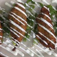 Stuffed Jalapenos · Jalapenos stuffed with chihuahua cheese topped with sour cream.