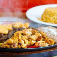 Fajitas · Your choice of meat with sauteed peppers and onions. Served with Mexican rice, beans, lettuc...