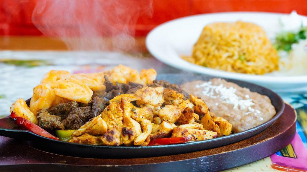 Fajitas · Your choice of meat with sauteed peppers and onions. Served with Mexican rice, beans, lettuce, sour cream, cheese, and flour tortilla.