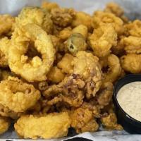 Island Calamari · Lightly hand-breaded, fried golden brown, served with our housemade Cajun remoulade dipping ...
