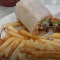 Steak Burrito · A flour tortilla rolled with rice, beans, Jack and cheddar cheese, sour cream and lettuce. S...