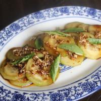 Sichuan Marinated Cucumbers  · Sliced cucumbers with soy sauce, sesame, sichuan chile oil, & basil