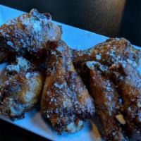 Crispy Chicken Wings · Marinated chicken wings fried to a golden crisp. Plain or your choice of housemade sauce: wh...
