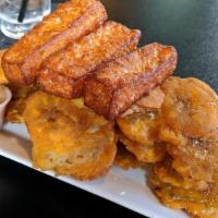 Golden Plantain Chips With Fried Cheese · Vegetarian. Thinly sliced plantains fried until golden, alongside sticks of fried Dominican ...