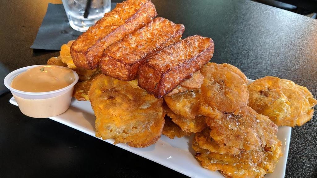Golden Plantain Chips With Fried Cheese · Vegetarian. Thinly sliced plantains fried until golden, alongside sticks of fried Dominican cheese. Served with our top mix dipping sauce.