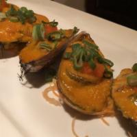 Grilled Mussels · Grilled green mussels with spicy sauce and tobiko on top.