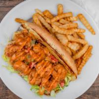Shrimp Po Boy · Marinated shrimp in hot sauce, bread and fried, then piled onto a French roll with lettuce, ...