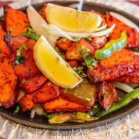 Paneer Tikka (Dry) · Marinated homemade cheese cubes baked in a tandoor clay oven with onions, bell peppers, and ...