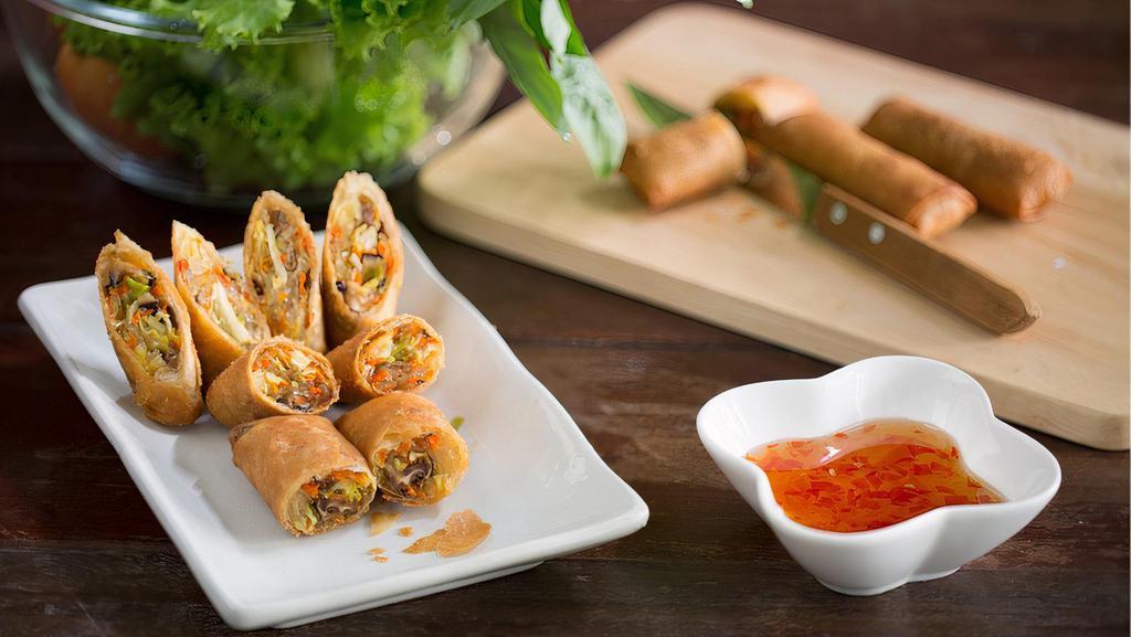 (3) Veggie Spring Rolls (Vegan) · Cabbage, carrots, mushrooms, noodles, and spices in a crispy spring roll served with Vietnamese dipping sauce.