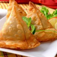 Veggie Samosa · Two pcs crispy triangular pastry turnovers filled with seasoned potatoes and green peas.
