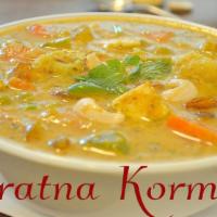 Navaratan Korma · A medley of nine vegetables cooked with mild creamy sauce with cashews and raisins.