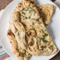 Garlic Naan · Bread stuffed with fresh minced garlic and herbs, baked in tandoor clay oven.