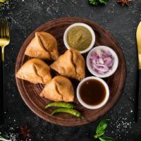 Vegetable Samosa · Flaky pastry dumplings filled with spiced potatoes, vegetables and deep fried till crisp and...