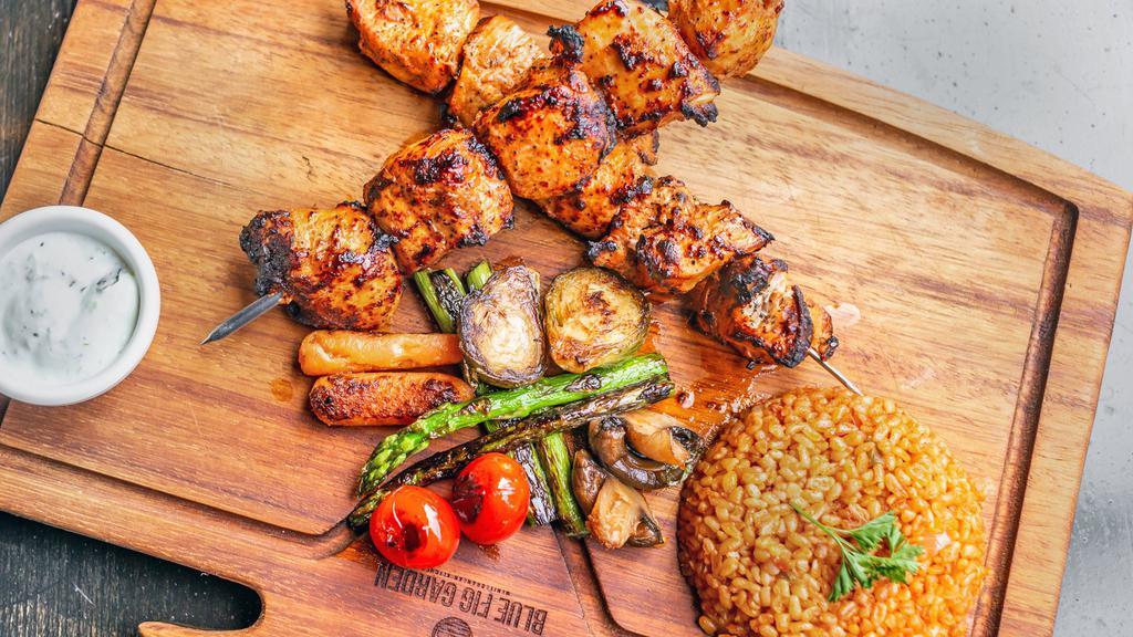 Chicken Kebab · Tender marinated char-grilled chicken cubes with touch of our house spice blend. Served with grilled vegetables and your choice of one of the side.