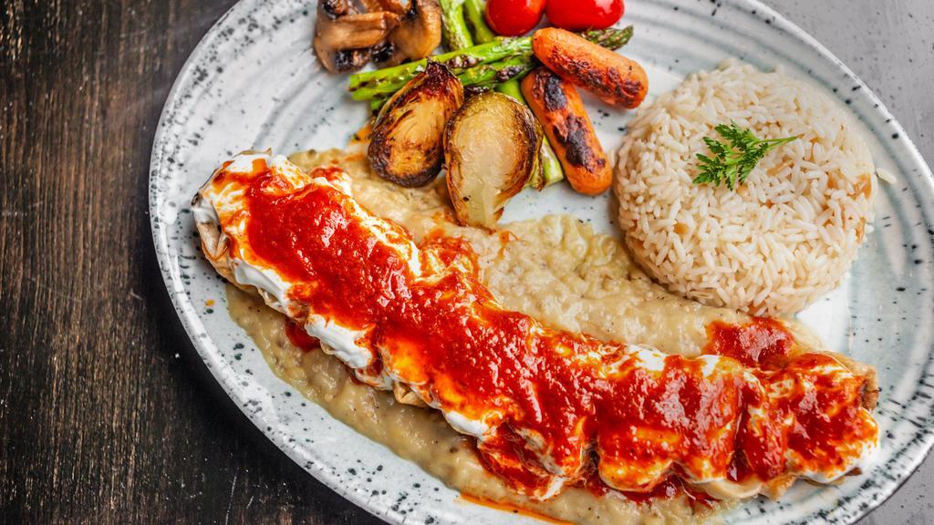 Beyti Kebab · Adana kebab and cheese wrapped in lavash, topped with homemade plain yogurt and drizzled tomatoes butter sauce. Served With grilled vegetables and your choice of one of the side.