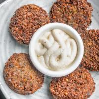 Falafel · Ground garbanzo mixed with onion, garlic and cilantro then deep fried.