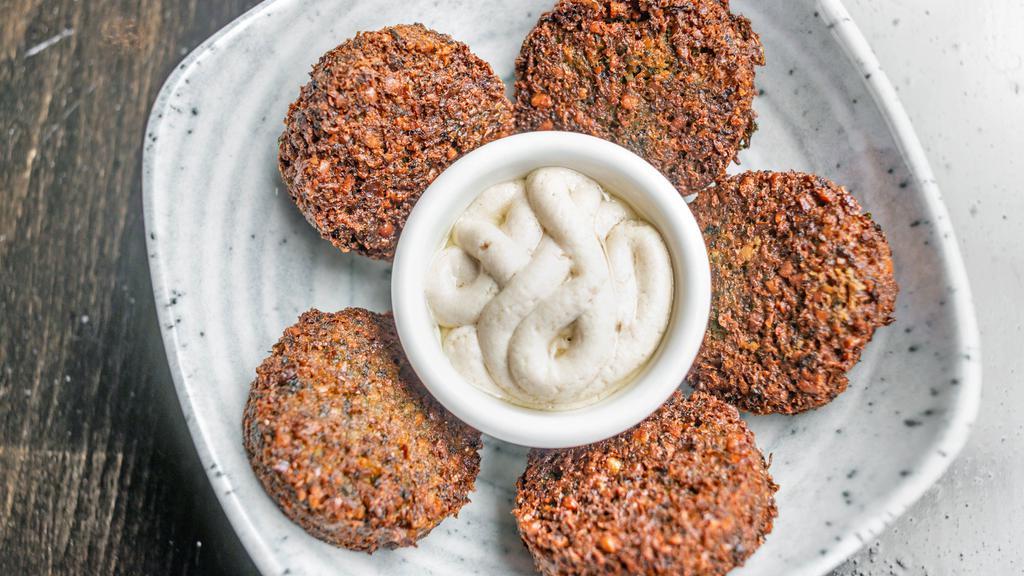 Falafel · Ground garbanzo mixed with onion, garlic and cilantro then deep fried.