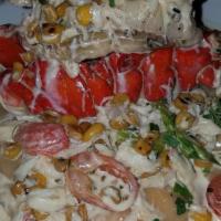 Lobster Ravioli · Petite lobster tail, lump crab meat, roasted corn, asparagus, cherry tomato, brandy cream sa...