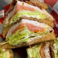 Turkey Club · Turkey Breast, Bacon, Lettuce & Tomatoes on triple white bread toasted   served with chips.