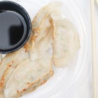 Gyoza (6) · Pan-fried pork dumpling served with a ginger soy dipping sauce.