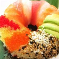 Sushi Donut · Pressed sushi rice with spicy tuna inside, topped with tuna, salmon, avocado, sesame seeds a...