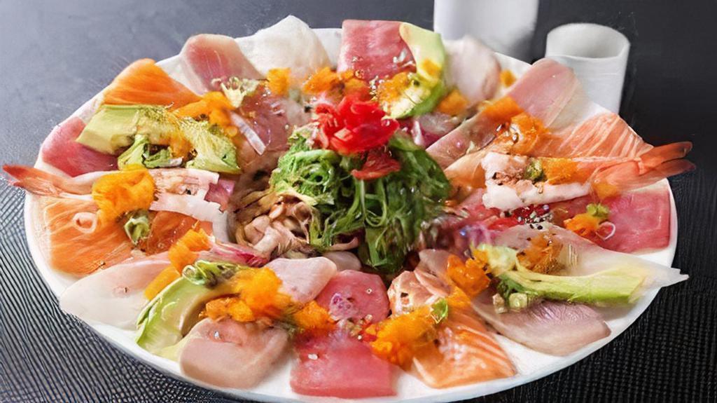 Rainbow Carpaccio · Thin, lightly, seared tuna, salmon, yellowtail, white tuna, topped with onion, scallion, tomato, sesame, and ponzu chili sauce.