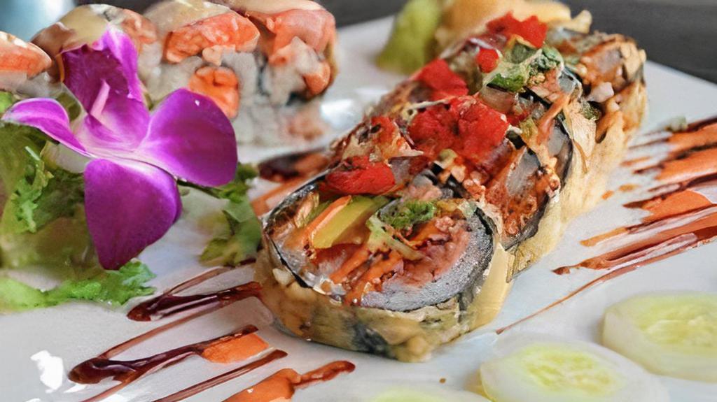 Dynamite Roll · Tuna, salmon, yellowtail, crab, avocado wrapped in seaweed deep fried, topped with masago, scallion, spicy eel sauce.