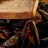 Pei Mussels · smoked garlic tomato sauce, white wine,  herbs, leeks, grilled house focaccia