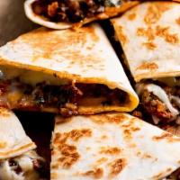 Grand Beef Quesadilla · Peppers, onions, jalapeño and mozzarella cheese. Served with fries and sour cream.