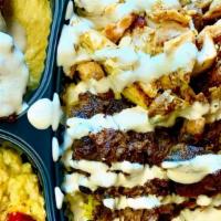 Mix Plate · A mix plate with 2 falafel, chicken shawarma, beef served with basmati rice topped with pick...