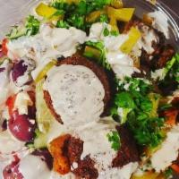 Mix Salad · 2 falafel, chicken shawarma and braised beef served over a greek salad topped with Mediterra...