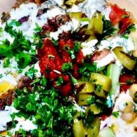 Kofta Hummus Bowl · Grilled grounded Lamb and beef  served with pickles and moroccain salad  over  homemade humm...