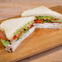 California Cobb Sandwich · Fresh avocado, romaine lettuce, tomato, smoked turkey breast, and crispy bacon with a bleu c...