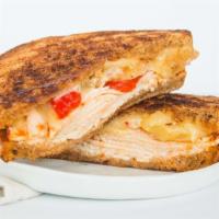 Spicey Smoked Turkey & Pepper Jack Panini · Smoked turkey breast, melted pepper jack cheese, roasted onions and peppers, sliced red onio...