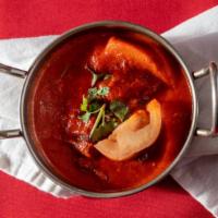 Lamb Vindaloo · Boneless lamb cooked with potatoes in a spicy & tangy sauce.