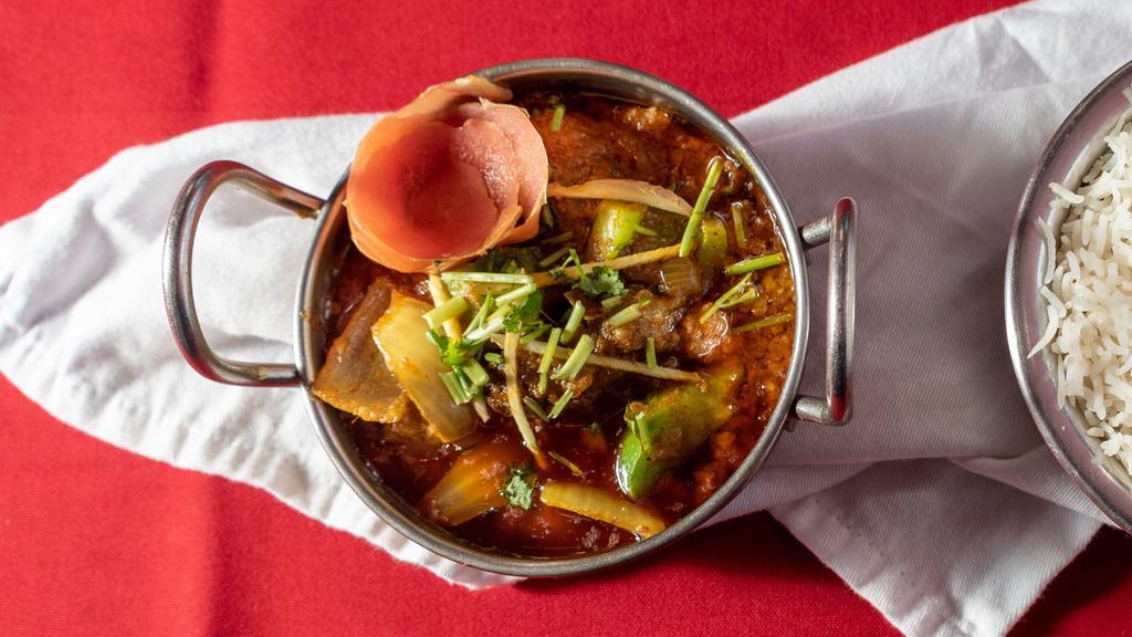 Goat Karahi · Bone-in goat cooked with tomatoes, bell peppers, and onions with Indian spices.