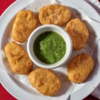 Chicken Nuggets · Home style 8 pieces of chicken nuggets served with tomato ketchup and hot sauce, tamarind, a...