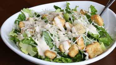 Caesar Salad · Crisp romaine lettuce tossed with homestyle croutons, grated Parmesan cheese and Caesar dressing.